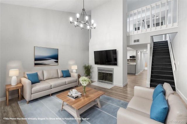 living room featuring light hardwood / wood-style floors and a notable chandelier