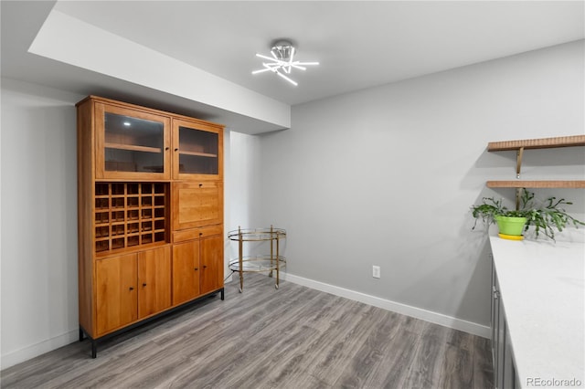 spare room featuring a chandelier and light wood-type flooring