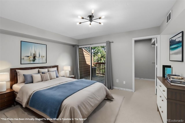 carpeted bedroom featuring access to exterior and a chandelier