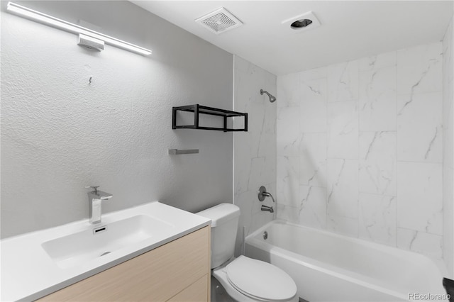 full bathroom with vanity, tiled shower / bath combo, and toilet