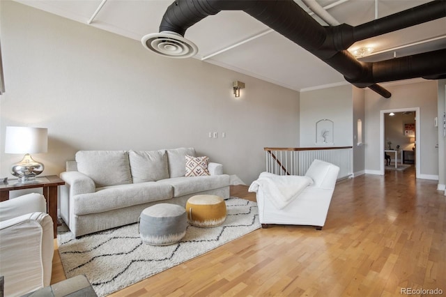 living room featuring hardwood / wood-style floors and crown molding