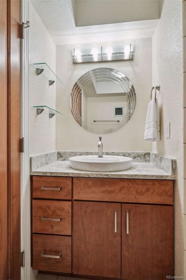 bathroom with vanity and a textured ceiling