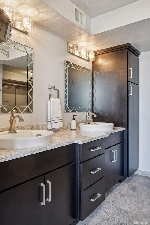 bathroom with vanity and a textured ceiling