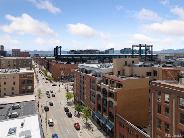 property's view of city with a mountain view