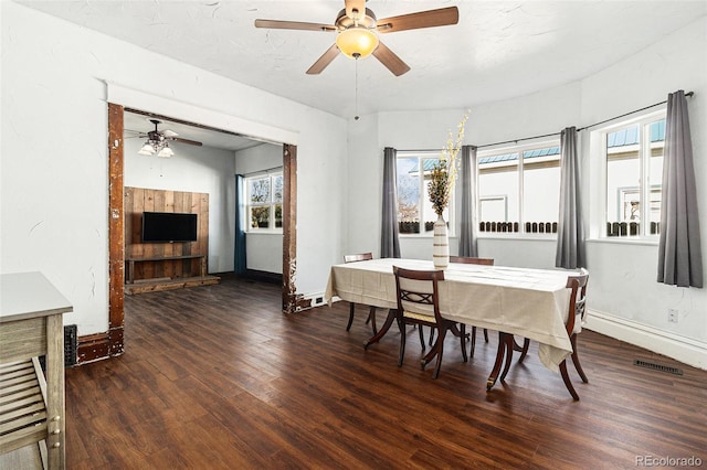dining area featuring baseboards, ceiling fan, wood finished floors, and visible vents
