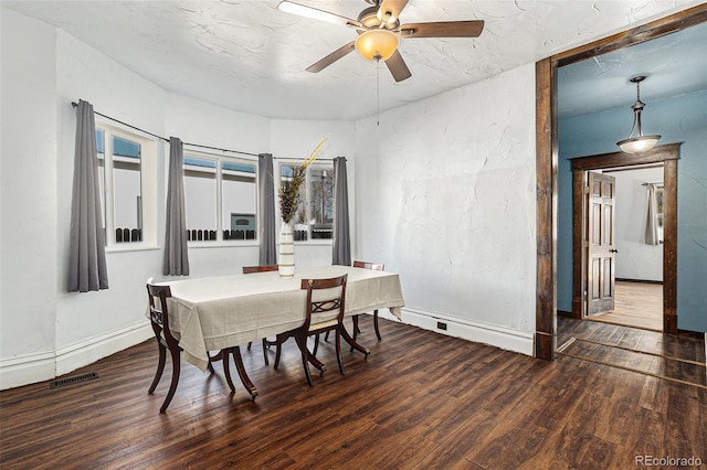 dining space featuring baseboards, a ceiling fan, wood finished floors, and visible vents