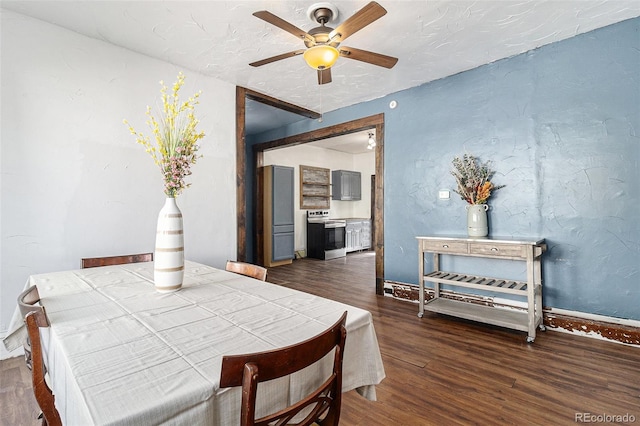 dining area with baseboards, a ceiling fan, and wood finished floors