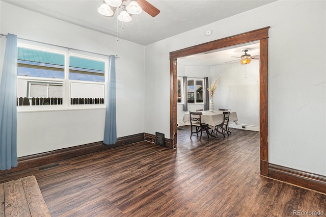 unfurnished room featuring baseboards, a ceiling fan, and wood finished floors