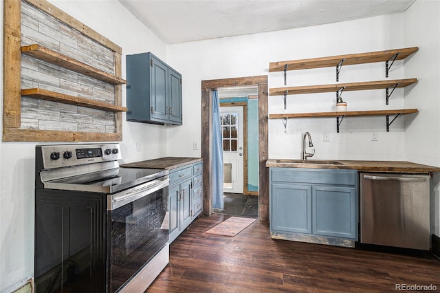 kitchen with open shelves, a sink, blue cabinetry, stainless steel appliances, and dark wood-style floors