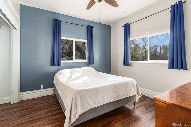 bedroom featuring baseboards, ceiling fan, and wood finished floors