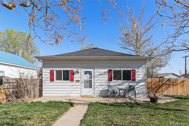 bungalow-style house featuring fence, a patio, and a front yard
