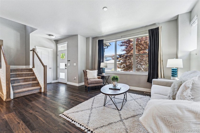 living room featuring a textured ceiling and dark hardwood / wood-style flooring