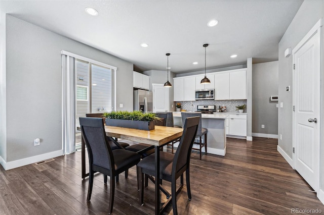 dining room with dark hardwood / wood-style floors