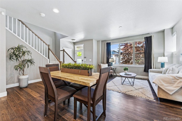 dining space with dark hardwood / wood-style flooring