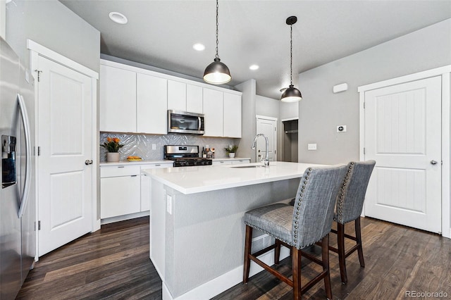 kitchen featuring white cabinetry, sink, an island with sink, and appliances with stainless steel finishes