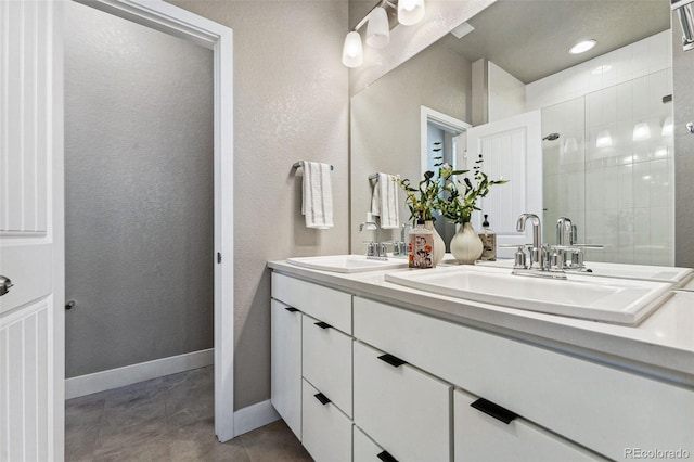 bathroom featuring tile patterned flooring, vanity, and a shower with shower door