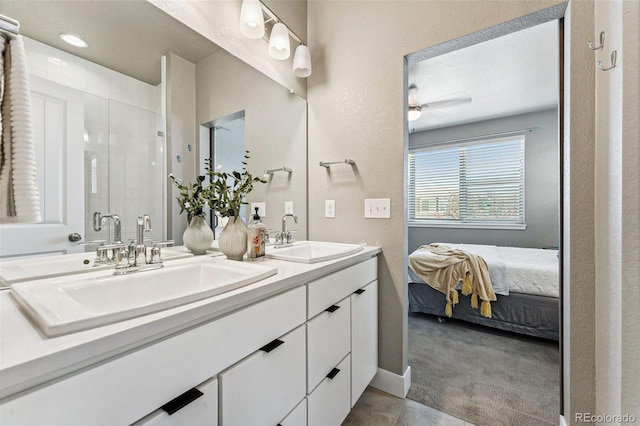 bathroom with vanity, ceiling fan, and walk in shower