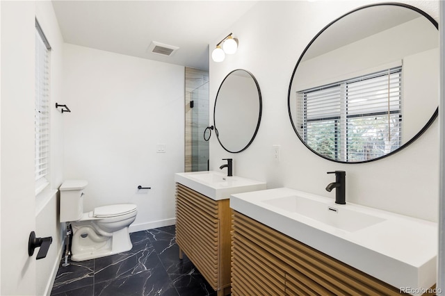 bathroom with toilet, a shower with door, and vanity