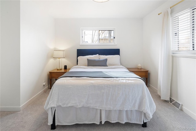 bedroom featuring light carpet