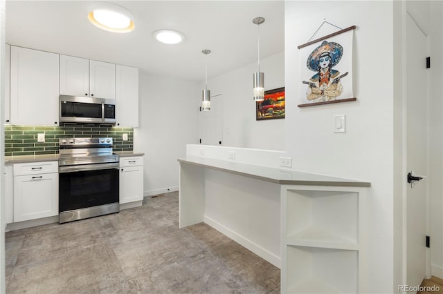 kitchen with white cabinets, pendant lighting, appliances with stainless steel finishes, and tasteful backsplash