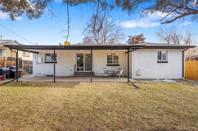 rear view of house with a patio area and a yard