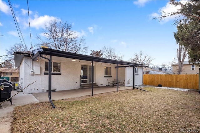 rear view of house with a yard and a patio