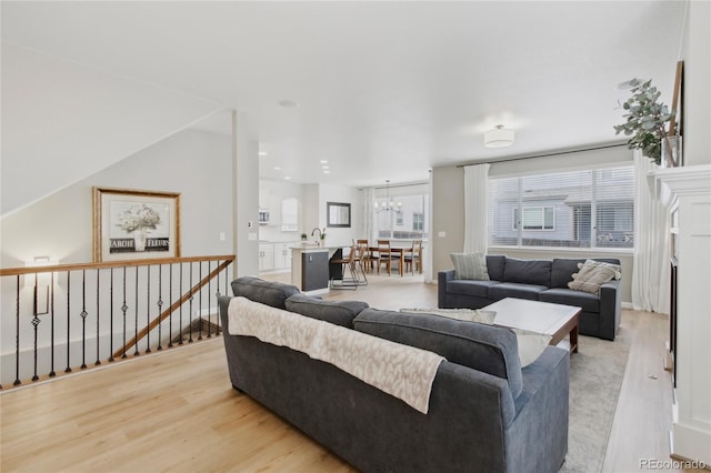 60 Stewart Way, Erie, CO 80516 - living room featuring light wood-style flooring and a chandelier