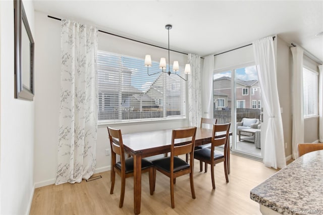 60 Stewart Way, Erie, CO 80516 - dining space with light wood finished floors, a chandelier, and baseboards