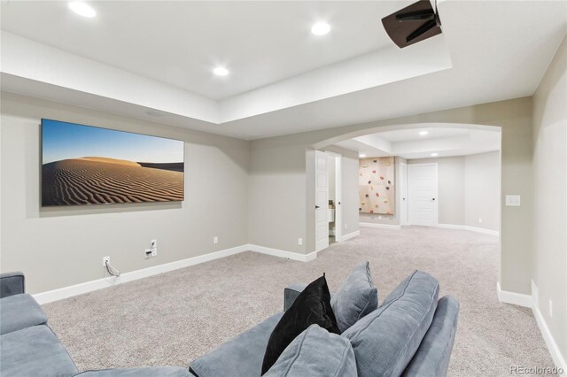 60 Stewart Way, Erie, CO 80516 - home theater featuring a tray ceiling, arched walkways, carpet floors, recessed lighting, and baseboards