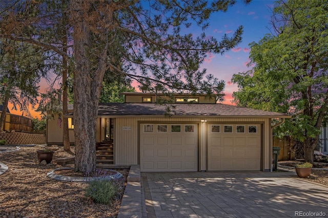 10858 E Harvard Dr, Aurora, CO 80014 - view of front facade featuring decorative driveway and an attached garage