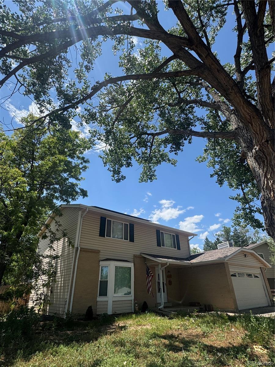 10611 Holland St, Broomfield, CO 80021 - traditional-style house featuring a garage