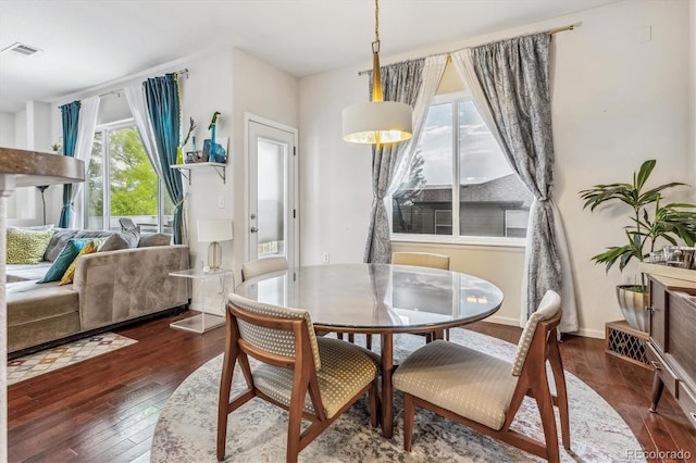 dining space with dark wood-type flooring