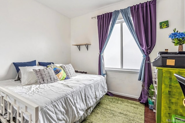 bedroom featuring wood-type flooring and multiple windows