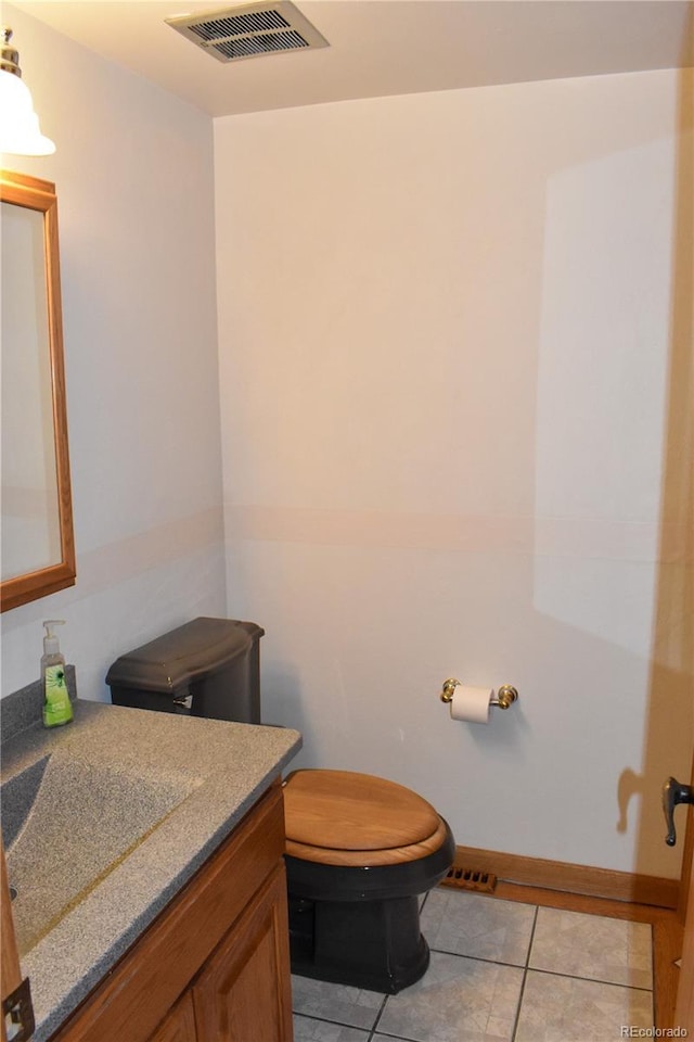 1040 Hemlock Way, Broomfield, CO 80020 - bathroom featuring vanity, toilet, tile patterned flooring, and baseboards