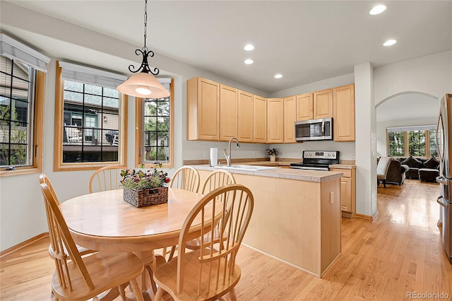 31139 Tahoe Ct, Evergreen, CO 80439 - kitchen featuring appliances with stainless steel finishes, light brown cabinetry, recessed lighting, and light wood-style floors