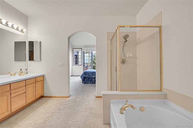 31139 Tahoe Ct, Evergreen, CO 80439 - ensuite bathroom featuring a garden tub, vanity, and tiled shower
