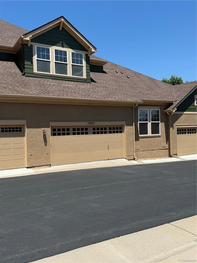 12317 W Gould Ave, Littleton, CO 80127 - view of front of home with a shingled roof and stucco siding