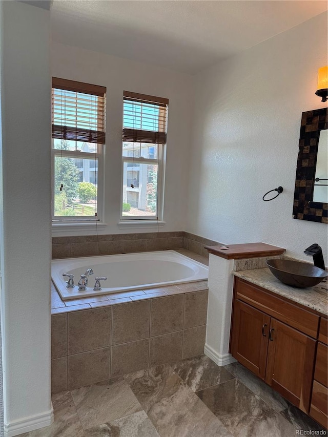 12317 W Gould Ave, Littleton, CO 80127 - full bathroom featuring a bath, vanity, and plenty of natural light