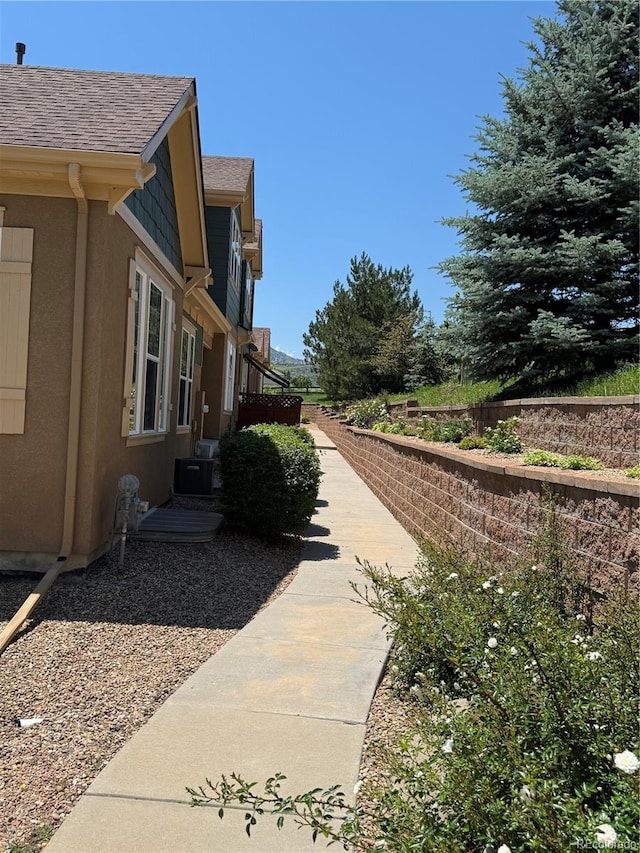 12317 W Gould Ave, Littleton, CO 80127 - view of side of home with roof with shingles and stucco siding