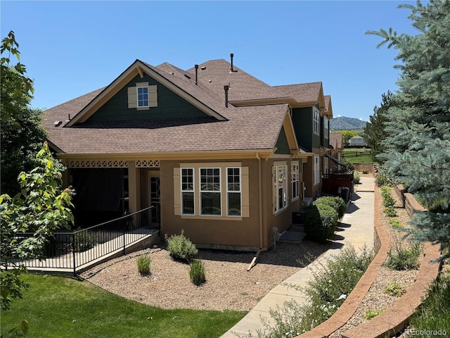 12317 W Gould Ave, Littleton, CO 80127 - rear view of property featuring roof with shingles, a patio area, and stucco siding