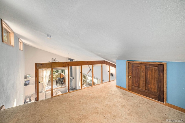 200 Crest Dr, Idaho Springs, CO 80452 - additional living space featuring vaulted ceiling, a textured ceiling, and carpet floors