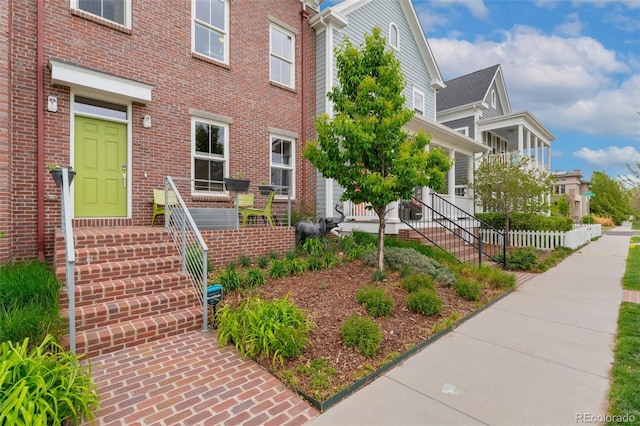 view of exterior entry with brick siding