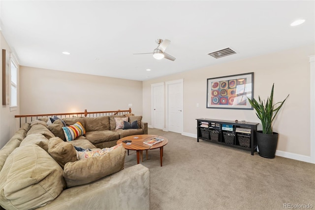 living room featuring recessed lighting, baseboards, ceiling fan, visible vents, and light carpet