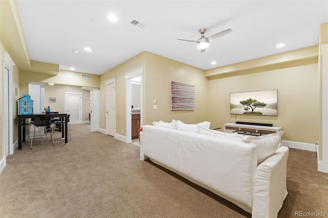 living area featuring light colored carpet, visible vents, recessed lighting, ceiling fan, and baseboards