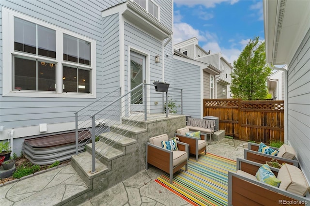 view of patio with an outdoor living space and fence