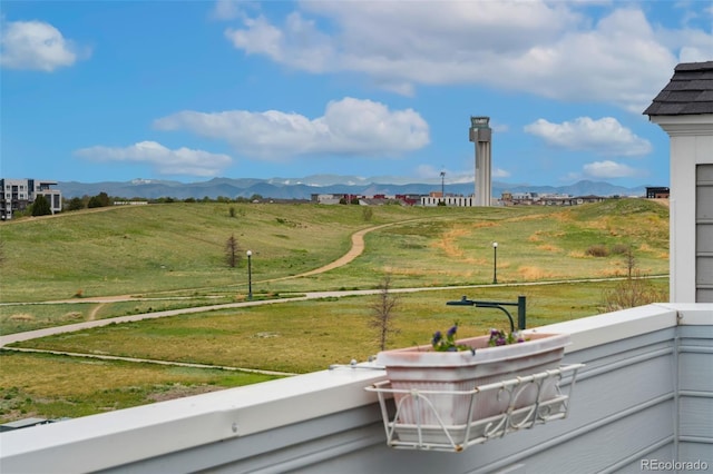 exterior space featuring a balcony and a mountain view
