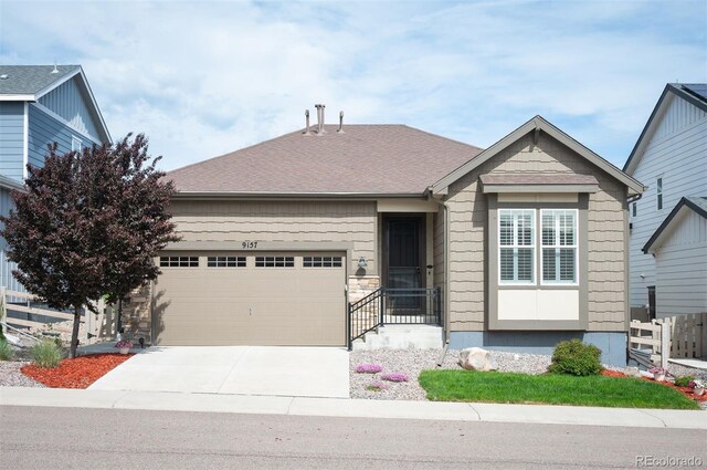 9157 Rio Lado St, Littleton, CO 80125 - view of front of property with a garage and concrete driveway