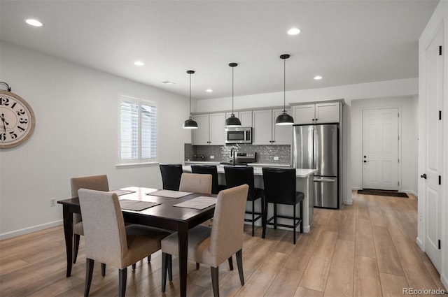 9157 Rio Lado St, Littleton, CO 80125 - dining space with light wood-style flooring, recessed lighting, and baseboards