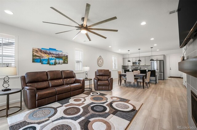 9157 Rio Lado St, Littleton, CO 80125 - living area with a ceiling fan, light wood-style flooring, recessed lighting, and baseboards