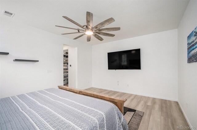 9157 Rio Lado St, Littleton, CO 80125 - bedroom with light wood-style flooring, baseboards, ceiling fan, and a spacious closet